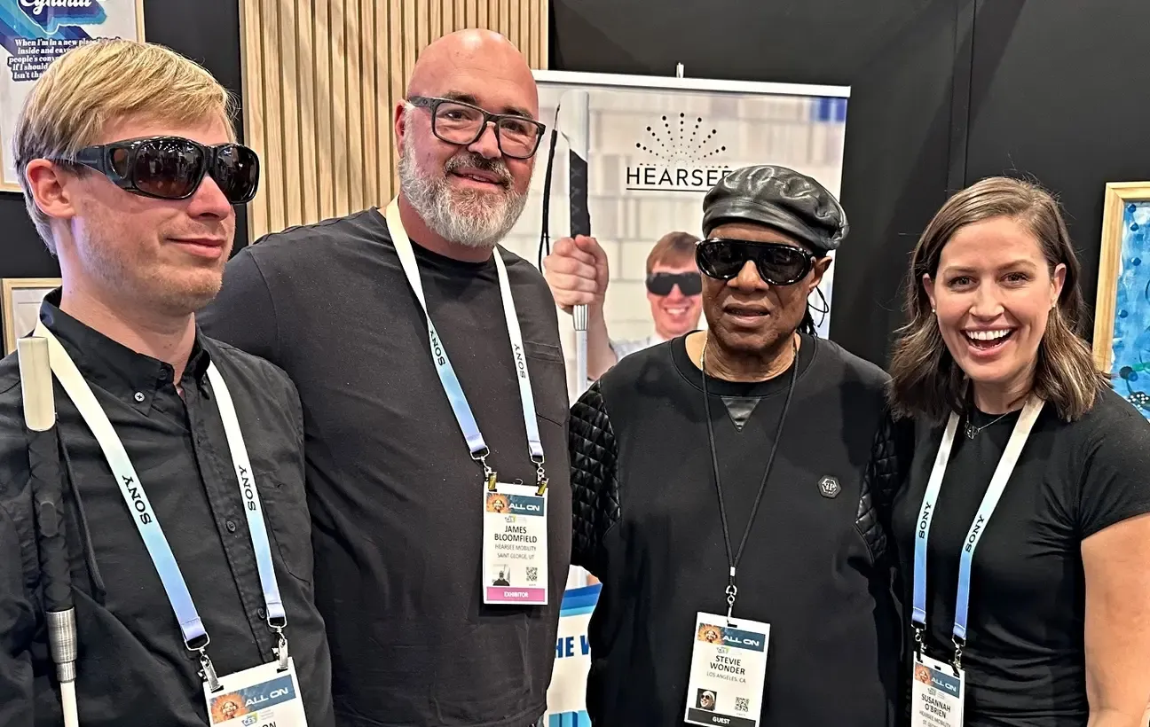 4 people posing together for picture