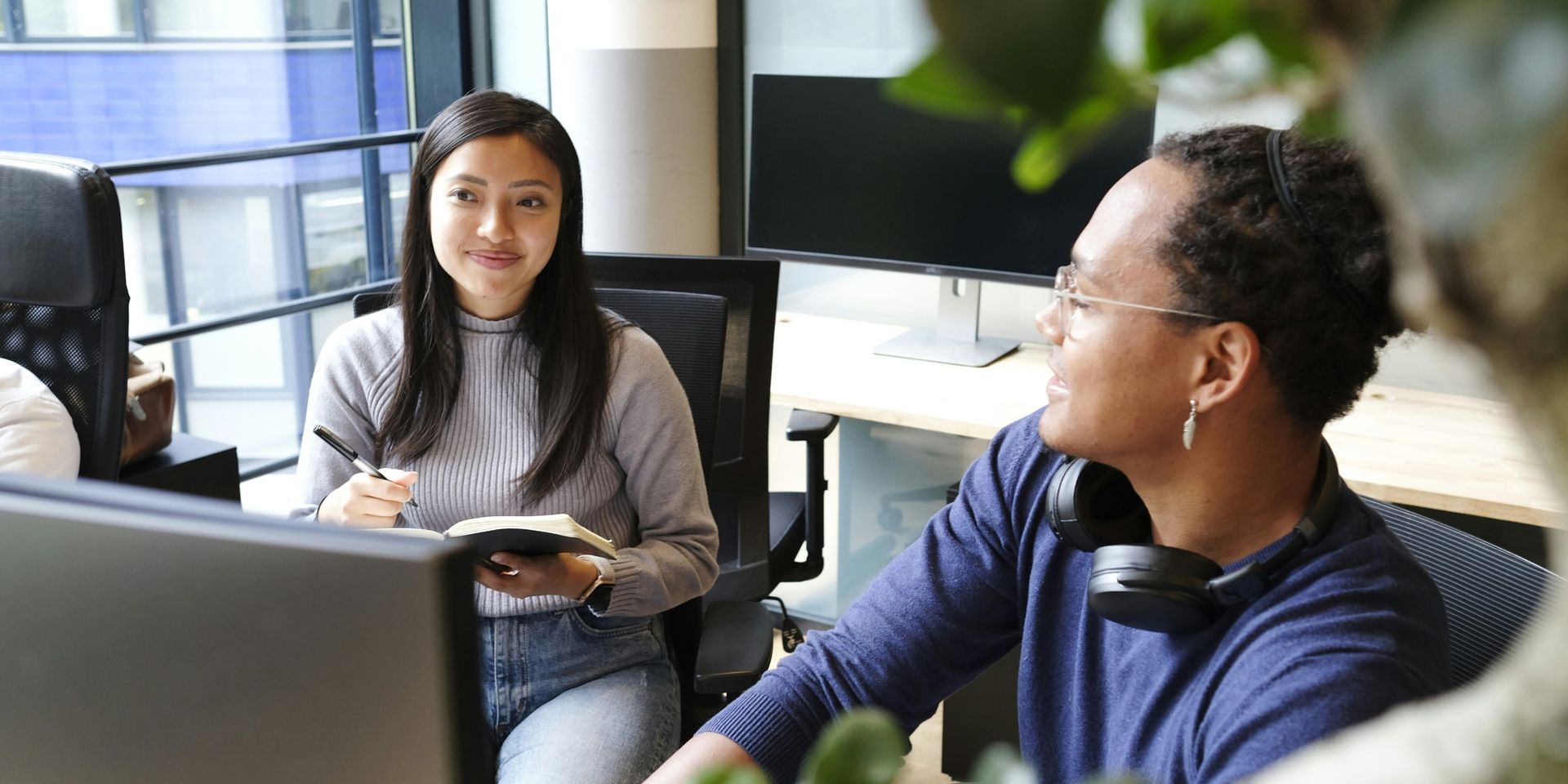 two developers sitting in front of computer screens