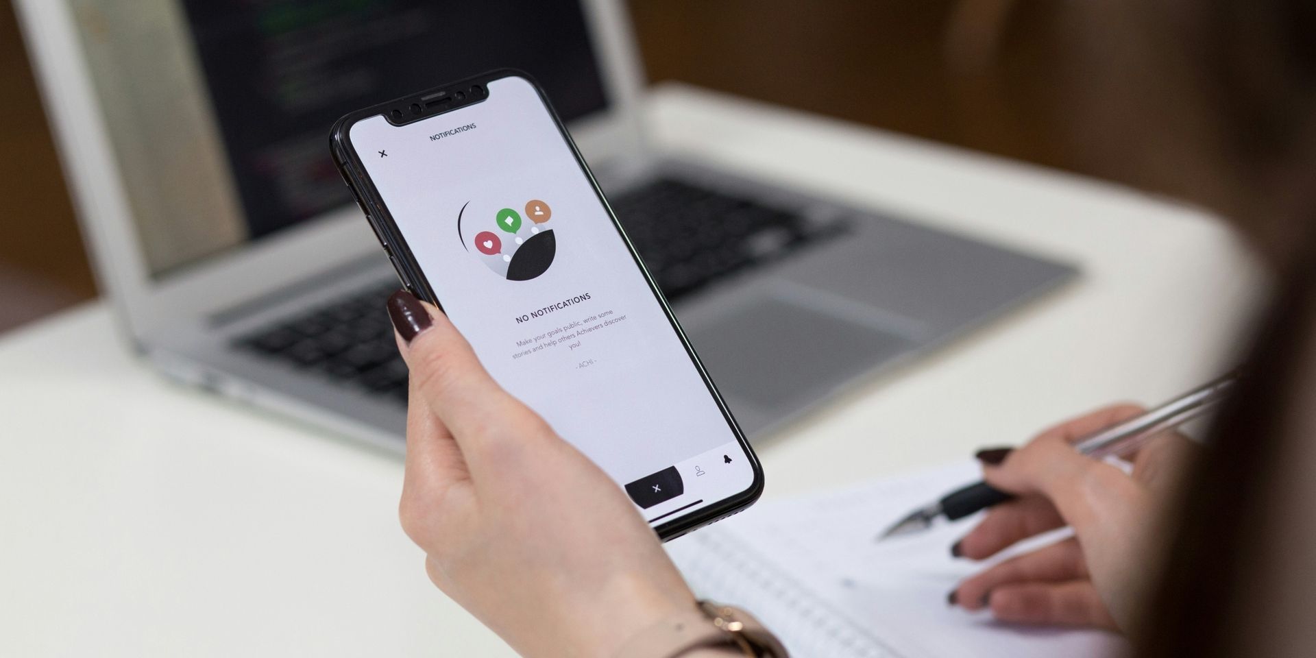 woman's hand holds a phone while testing an app