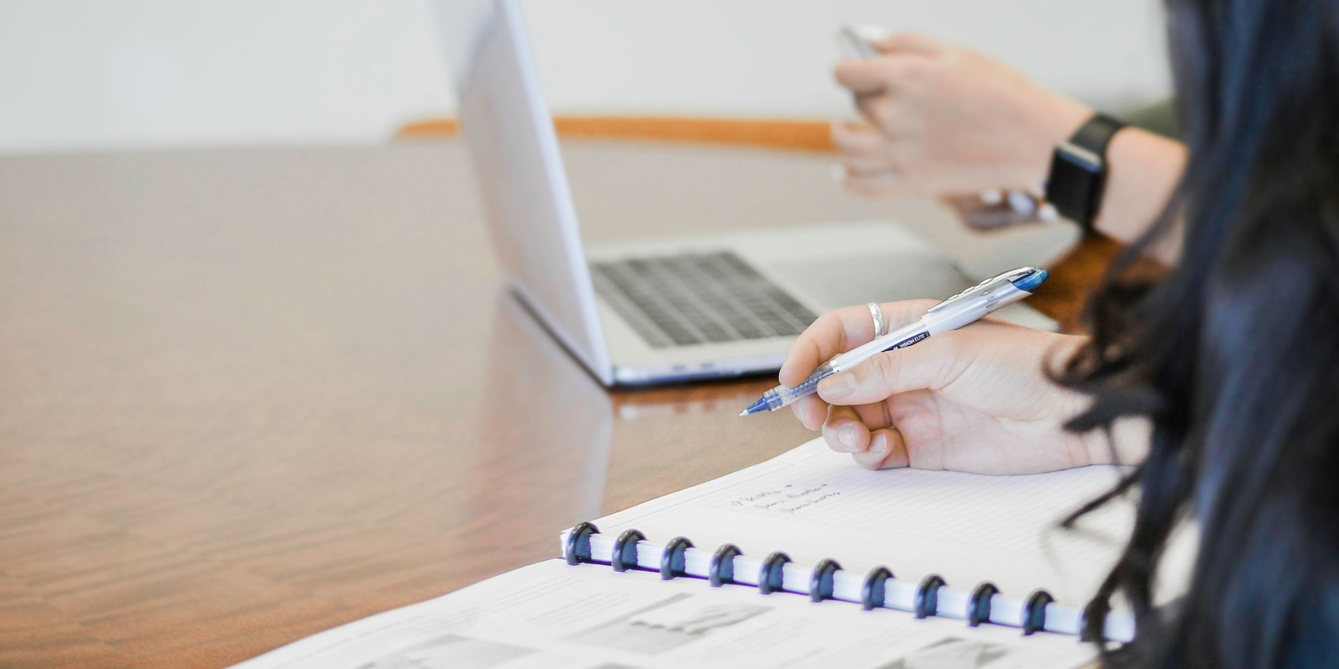 strategizing with a notebook and laptop