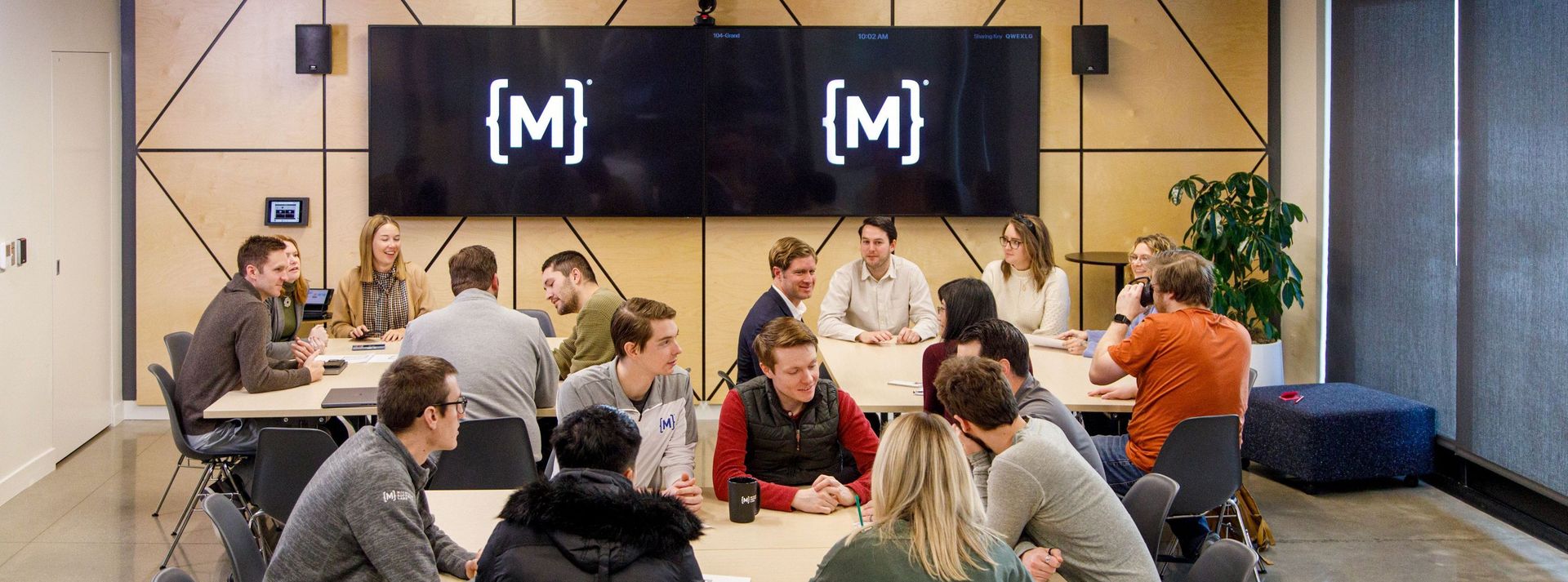 team members sit around tables