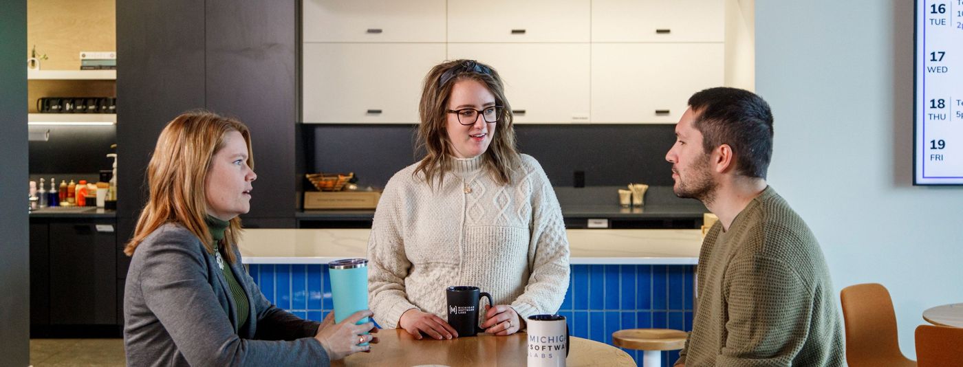 Conversation between 3 people in a lobby