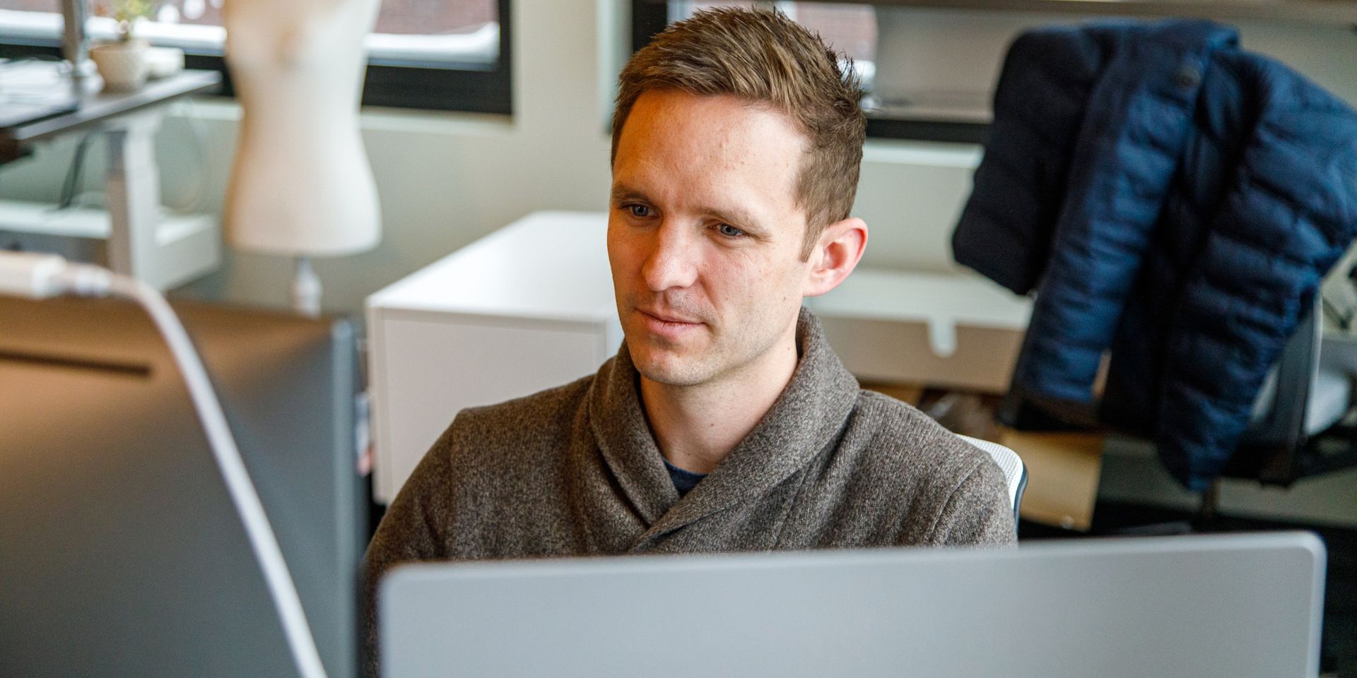 male developer looks at computer