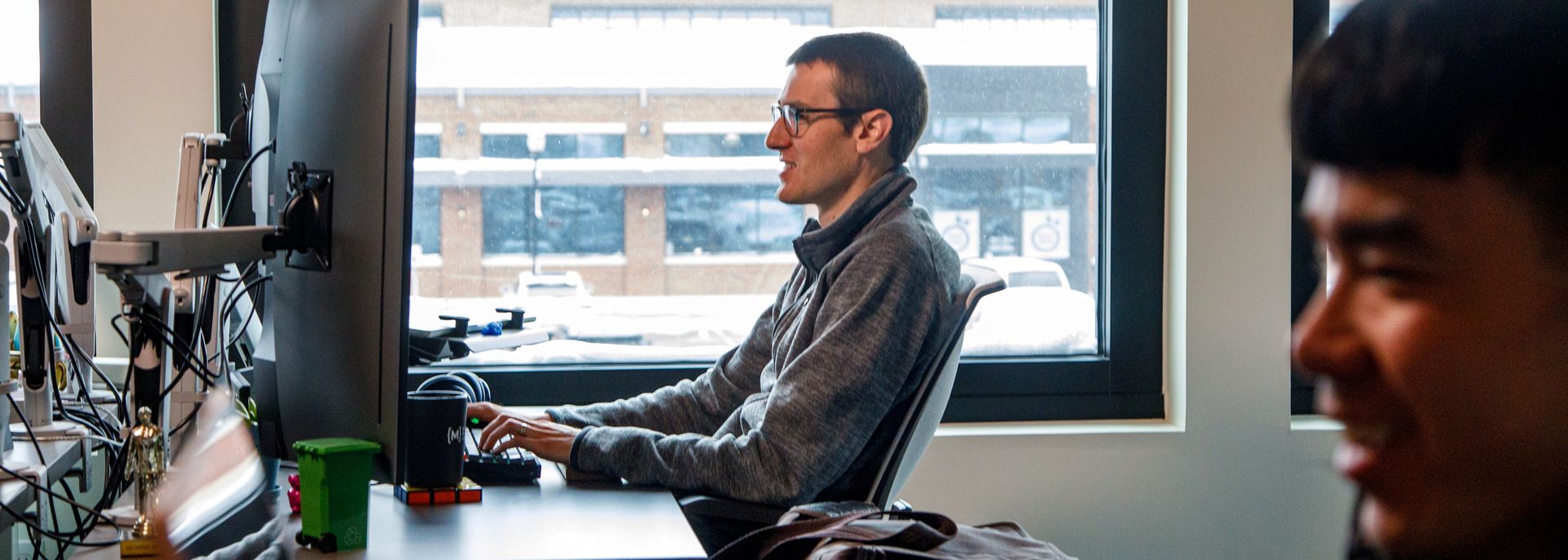 two developers work at their desks