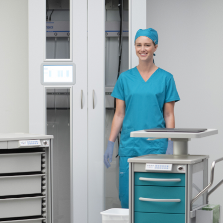 Woman in medical scrubs with medical cart